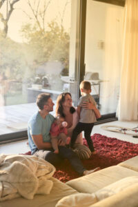 Family enjoying the natural sunlight through a glass door.
