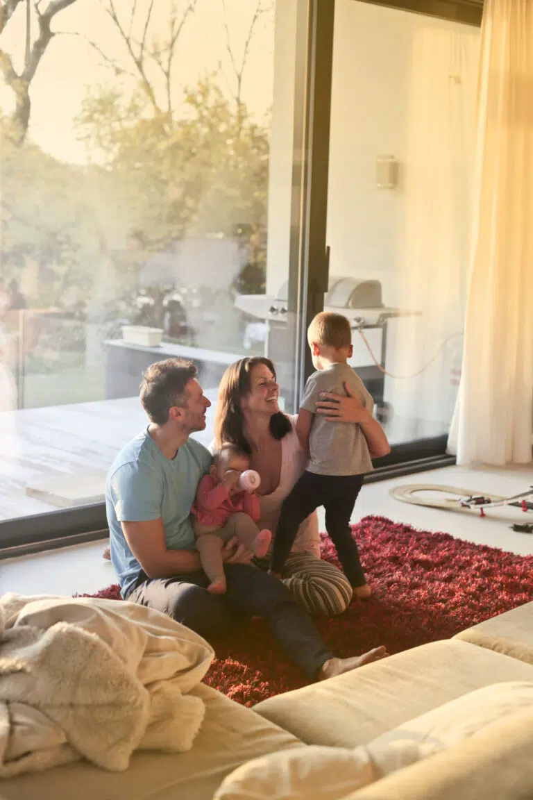 Family enjoying the natural sunlight through a glass door.