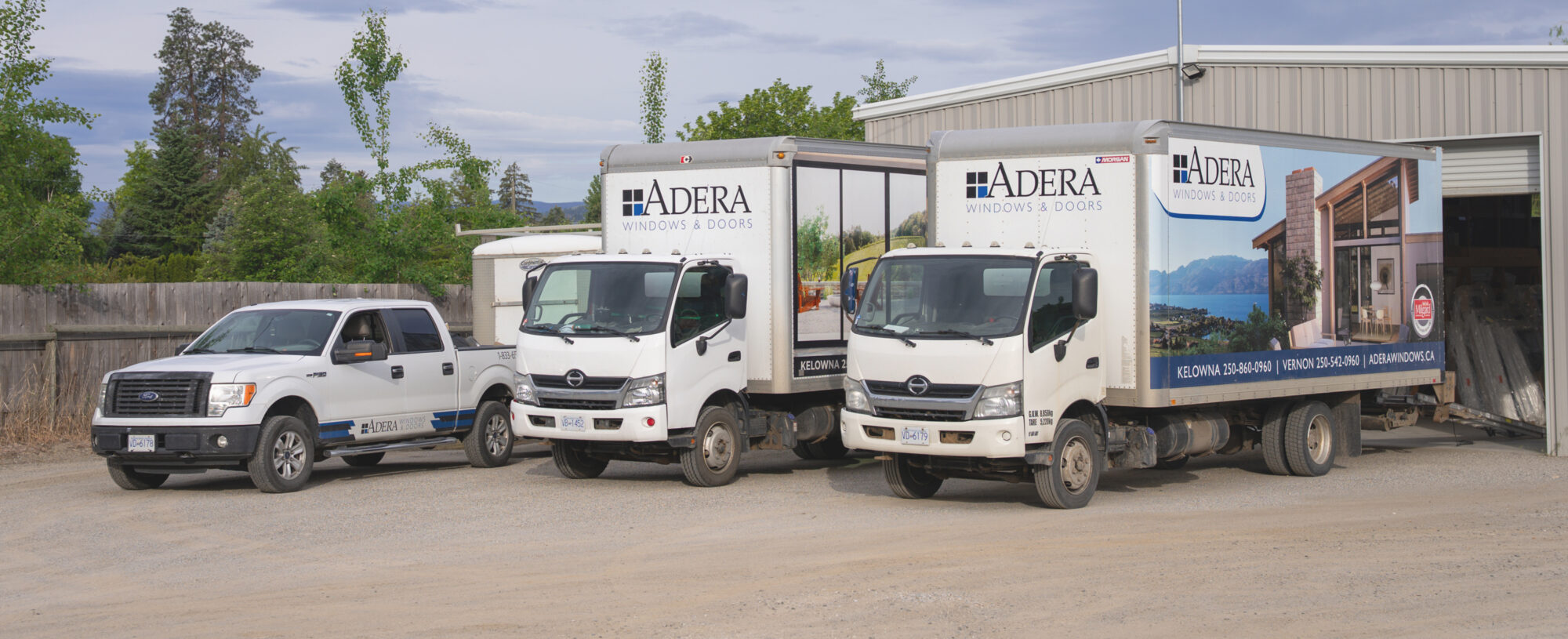 The Adera Windows & Doors fleet parked side-by-side in the Okanagan.