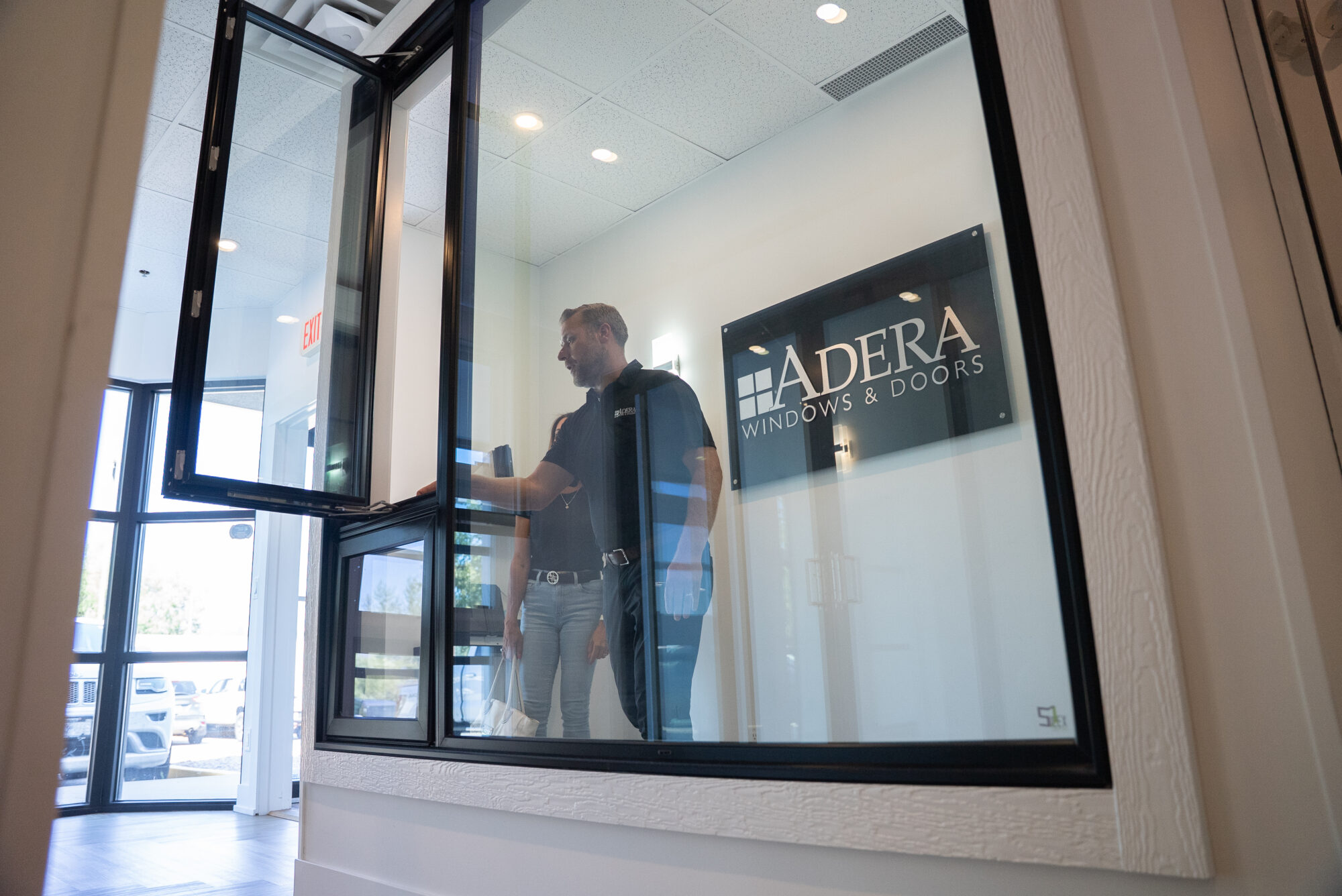 Man and woman at Adera Windows & Doors' Kelowna showroom, looking at window options