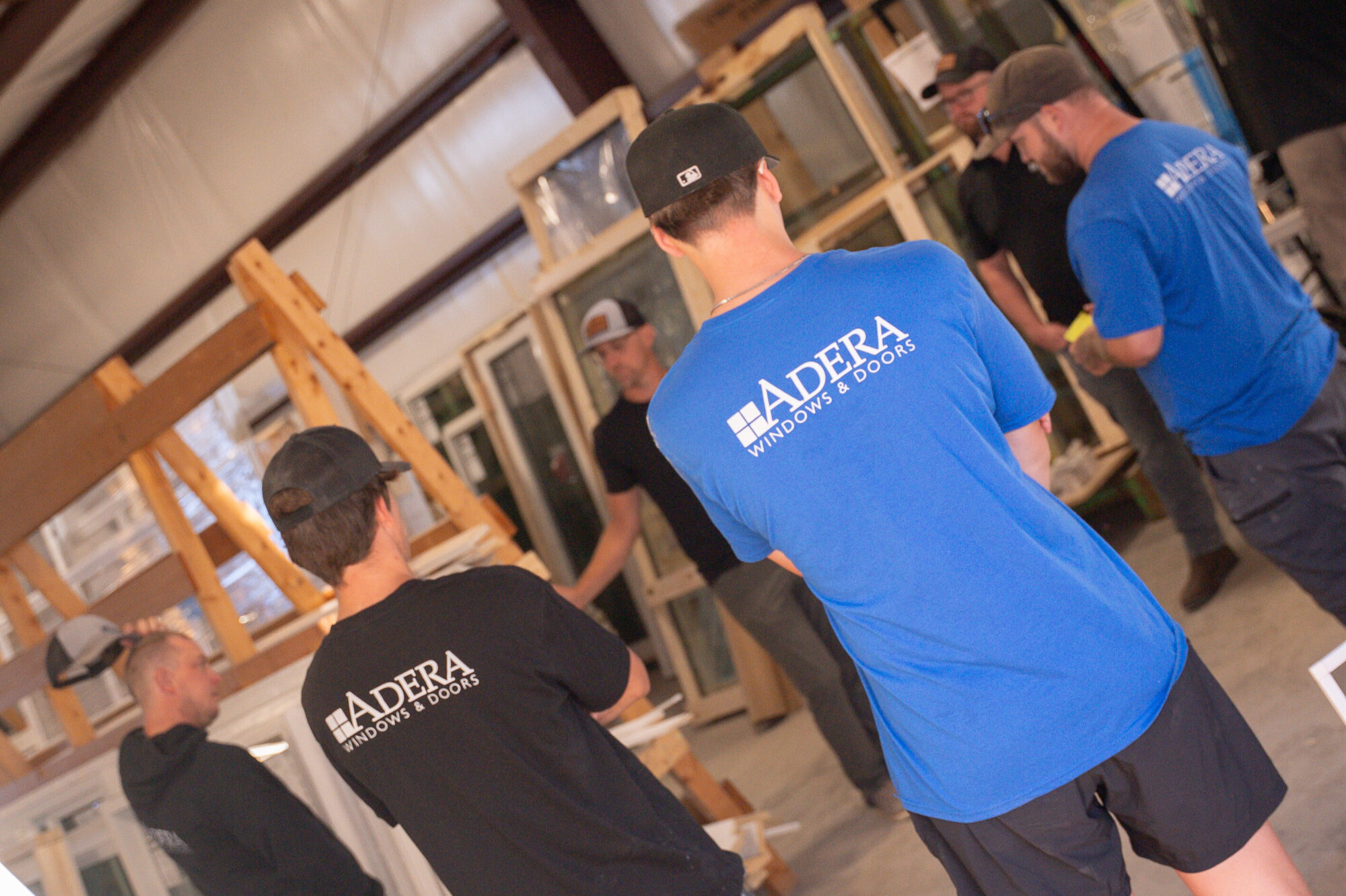 The team at Adera Windows & Doors getting a briefing in the warehouse full of windows and doors in Kelowna, BC