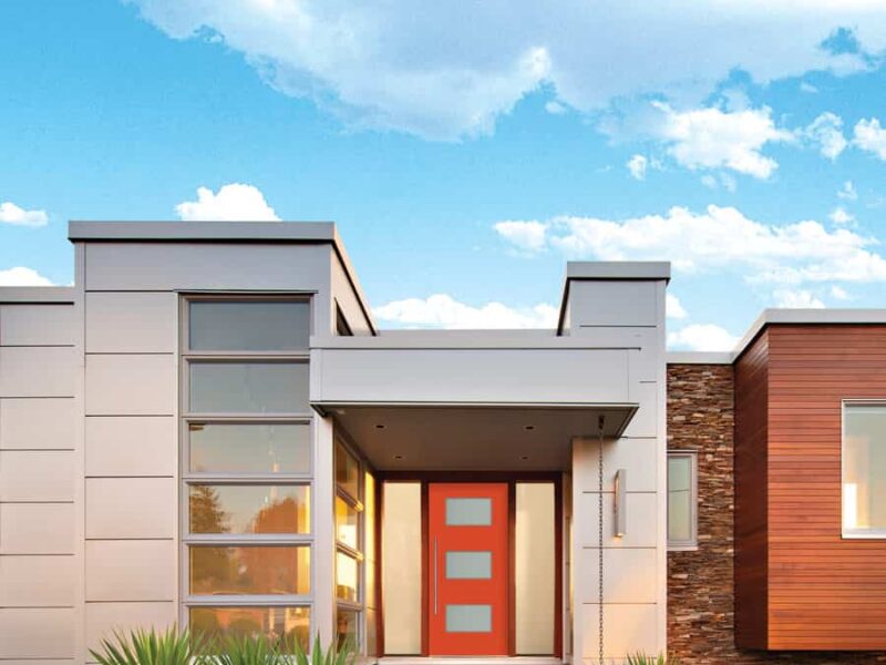 New modern entry door installed on Okanagan home with muted landscaping that enhances curb appeal.