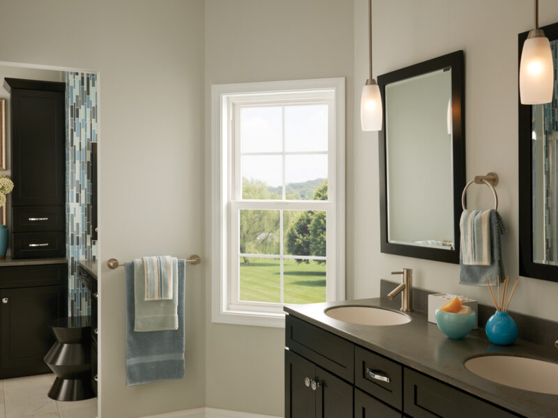 Bathroom window with grid mullions allowing natural light into a modern bathroom interior.